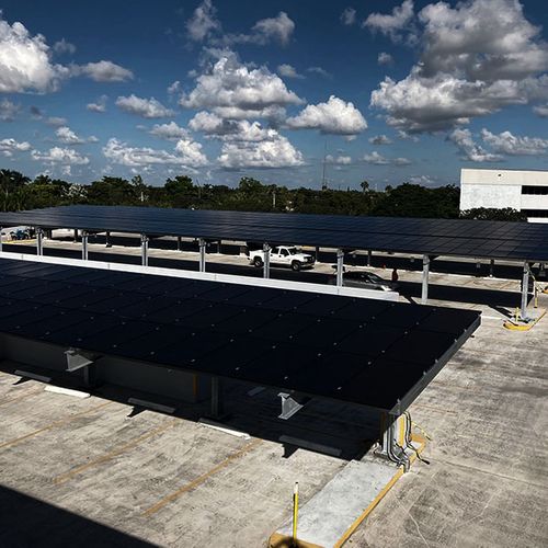 Commercial building with rooftop solar panel array and parking lot